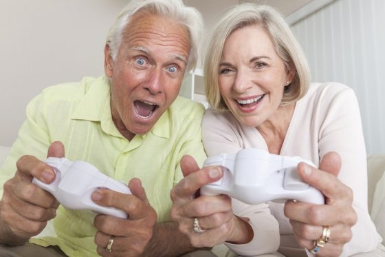 Senior Man & Woman Couple Playing Video Console Game