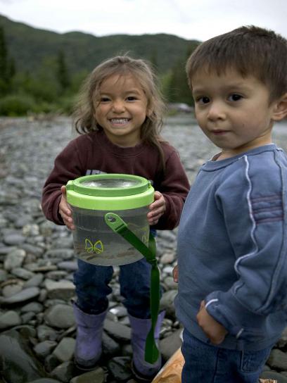 two-young-children-enjoying-a-day-of-fishing-on-a-river-408x544